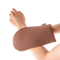 Arm being exfoliated by a brown mitt