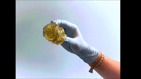 Animation of sugaring paste being rolled in a gloved hand