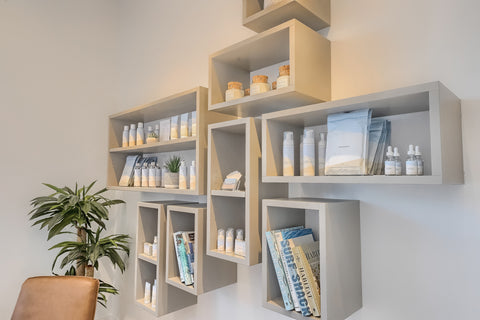 Modern wall-mounted shelves with various items against a light background