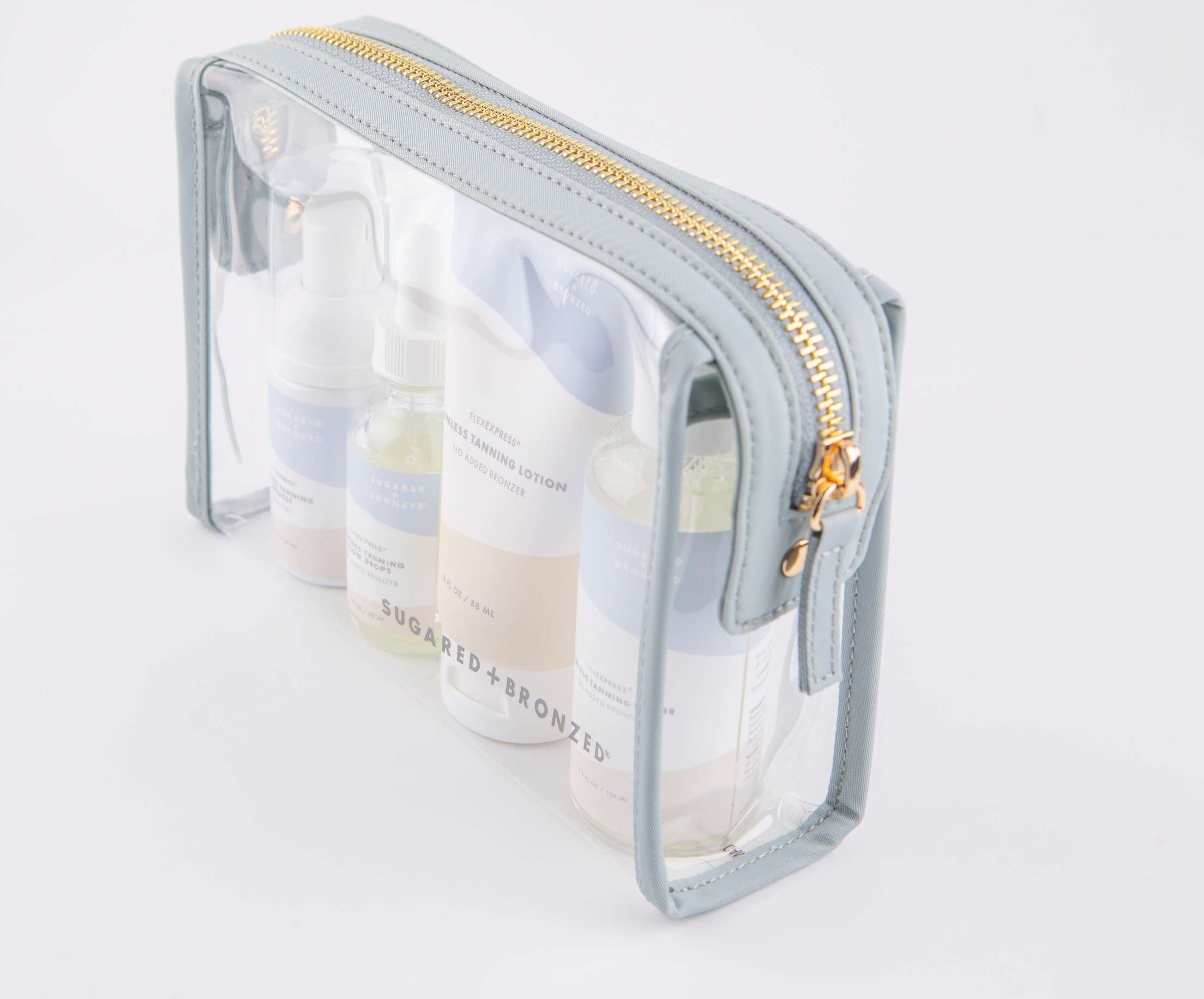 See-through bag holding bottles of Sugared and Bronzed tanning products.