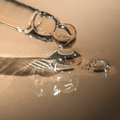Close-up of a tincture dropper with oil droplets on a beige background