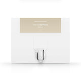 A white box with a dispenser faucet for Elixir One tanning solution