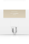 A white box with a dispenser faucet for Elixir One tanning solution