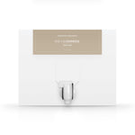 A white box with a dispenser faucet for Elixir Two tanning solution