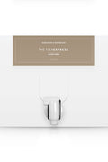 A white box with a dispenser faucet for Elixir Three tanning solution