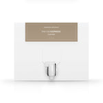 A white box with a dispenser faucet for Elixir Three tanning solution