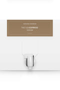 A white box with a dispenser faucet for Elixir Four tanning solution