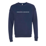 Navy blue sweater featuring the Sugared and Bronzed logo in white
